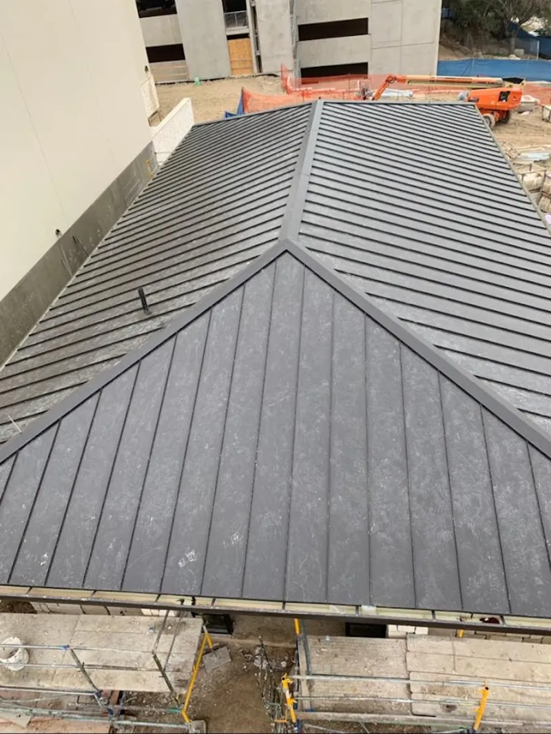 Commercial metal roof construction with crane equipment in South Pasadena